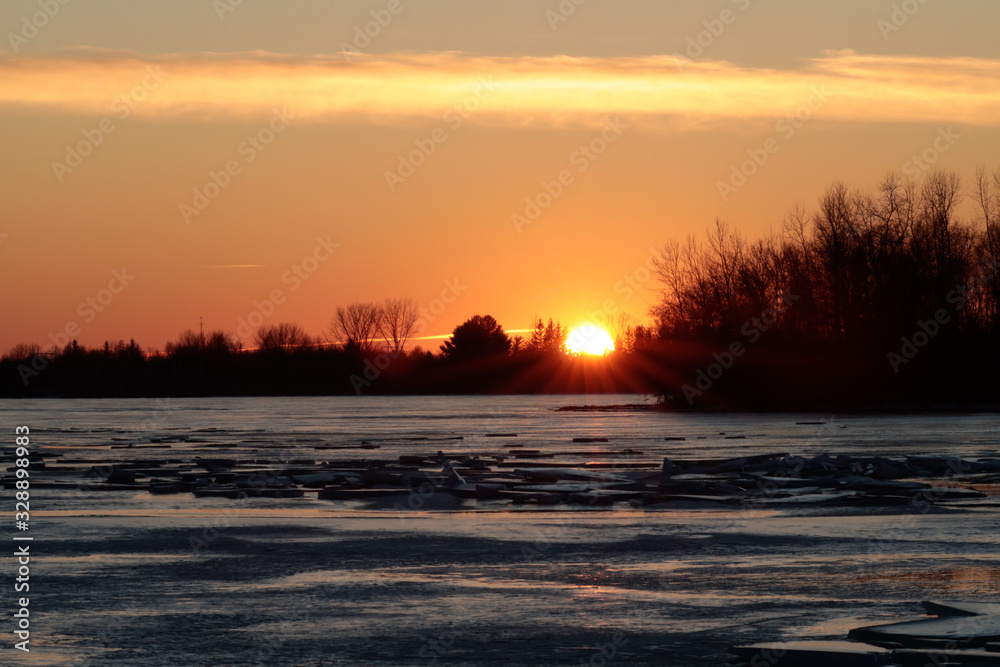 sunset over a frozen river