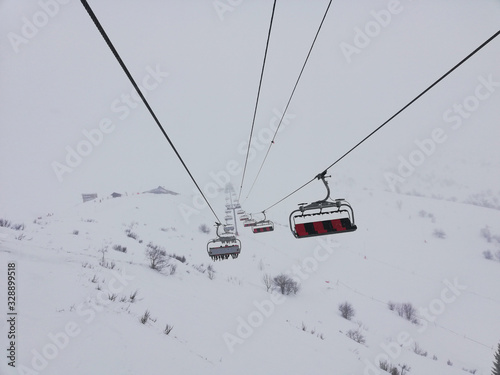 chairlifts going into the mist