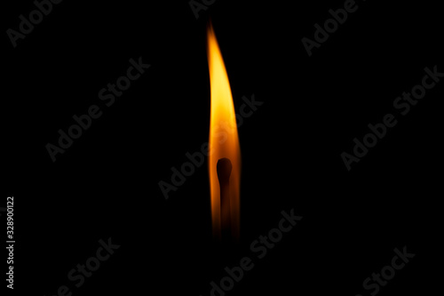 burning match on a black background