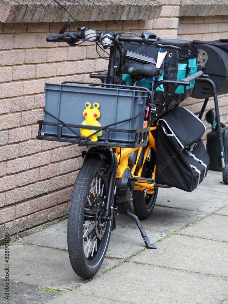 an electric cargo bike with pannier bags and crates