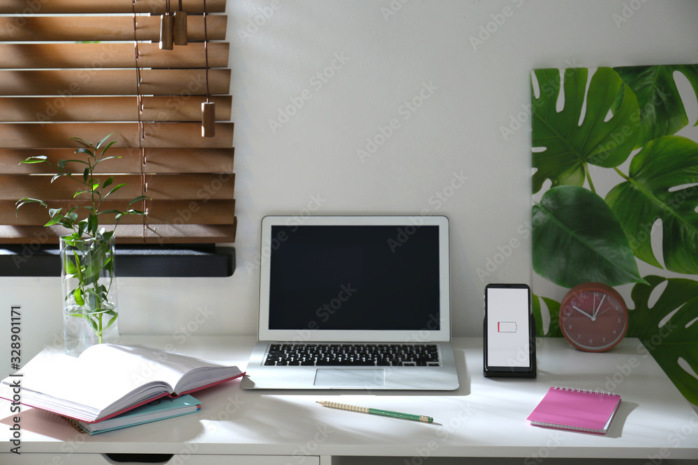 Modern workplace and smartphone charging with wireless pad Modern workplace and smartphone charging with wireless pad