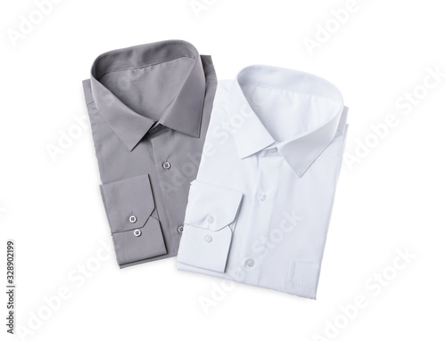 Stylish shirts isolated on white, top view. Dry-cleaning service