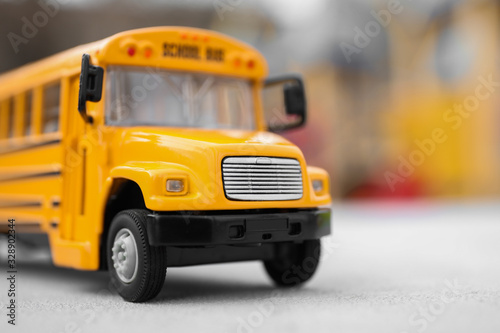 Yellow toy school bus against blurred