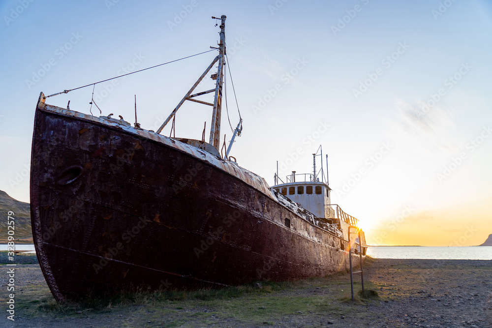 An out-of-the-way whaling ship that wrecked on the beach to Latrabjarg during sunset