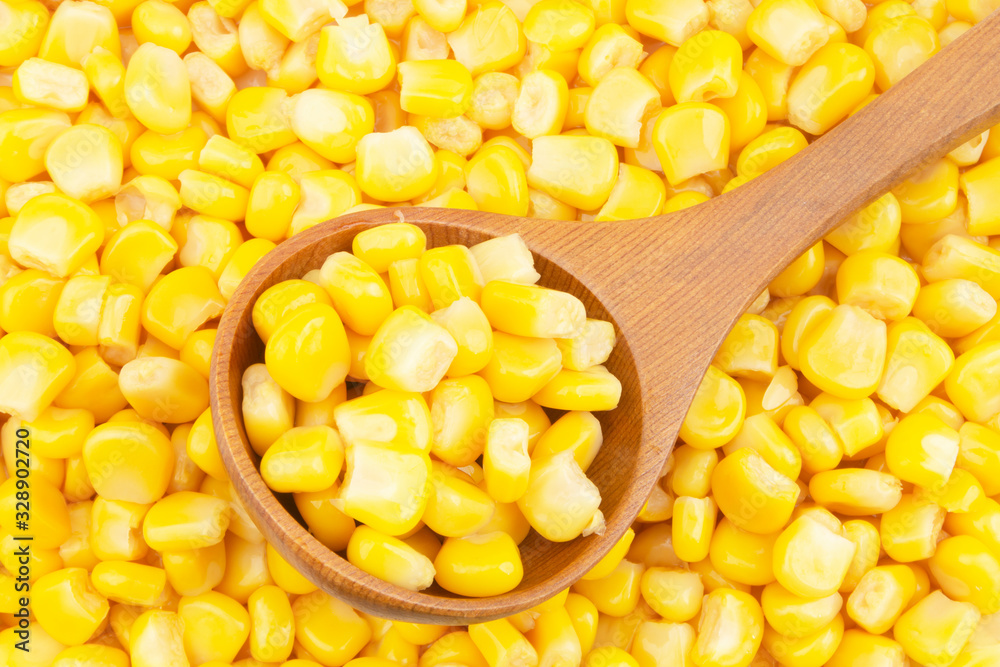 Fototapeta premium Canned corn with wooden spoon
