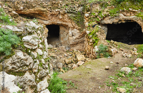 Caves in stone covered with moss and grass, in the south of Israel in the spring