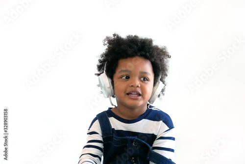 Portrait of a cute 3 yars old boy wearing earphone isolated on white background , kids concept,technology concept.