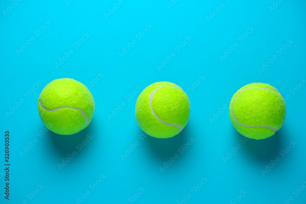 three tennis balls on a bright blue background