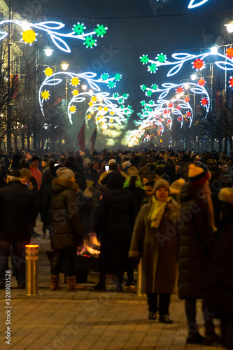 VILNIUS, LITHUANIA - FEBRUARY 16, 2020: Hundreds of people attending the celebration of Restoration of the State Day in Vilnius. Bonfires are lit on Gediminas avenue on festive night on February 16.