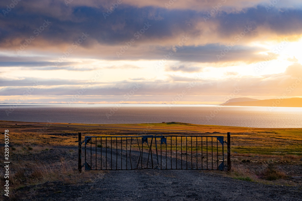A Misty Landscape with Gate and dramatic cloudscape during Sunset. Concept of passing to heaven 