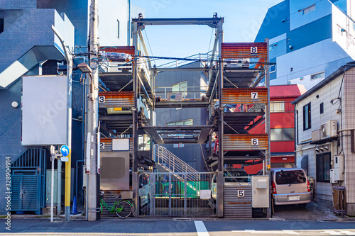 Japan. Automated parking station in Tokyo. A parking place in Japan. A multi-storey car park in the middle of buildings. Place for car-park in Tokyo. Car-park in a densely built-up area