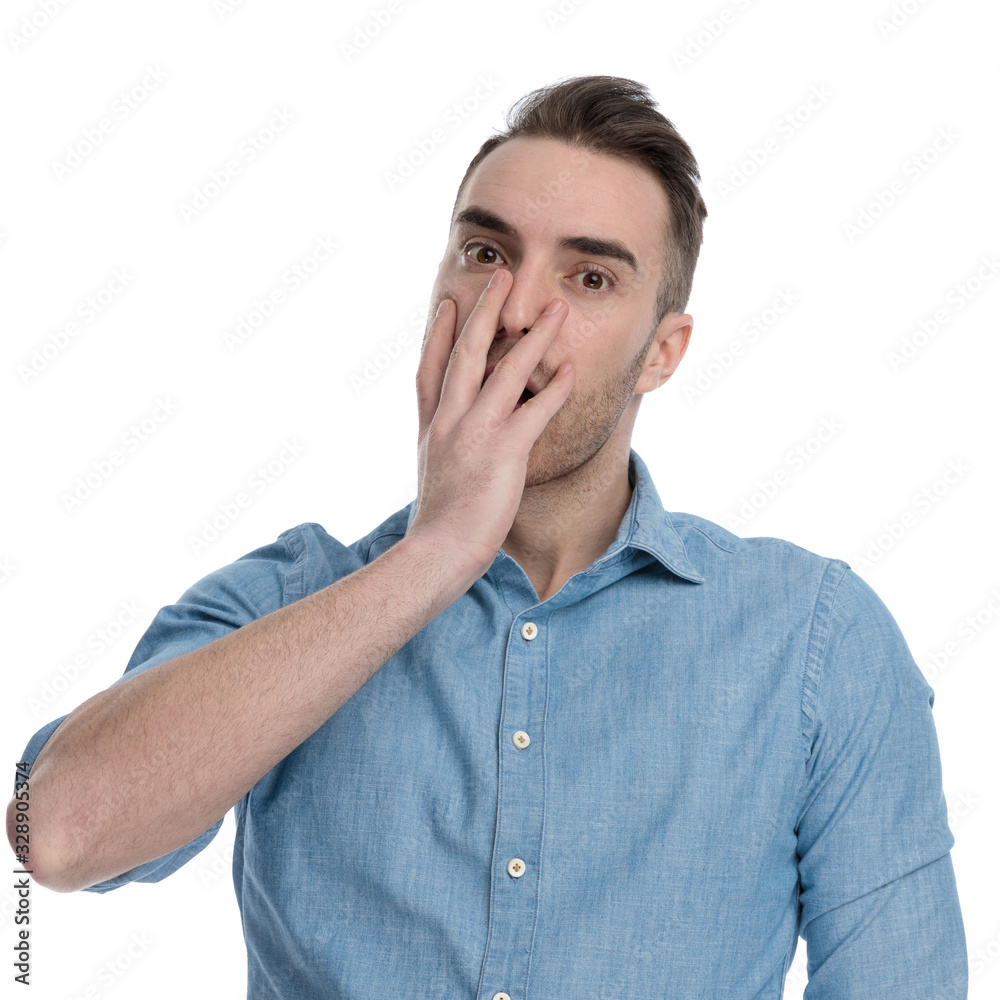 Amazed casual man gasping and covering his mouth Amazed casual man gasping and covering his mouth