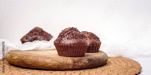 Chocolate muffins. Delicious cupcakes on white table.