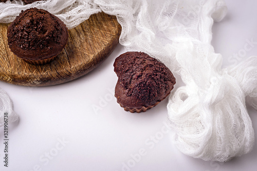 Chocolate muffins. Delicious cupcakes on white table.