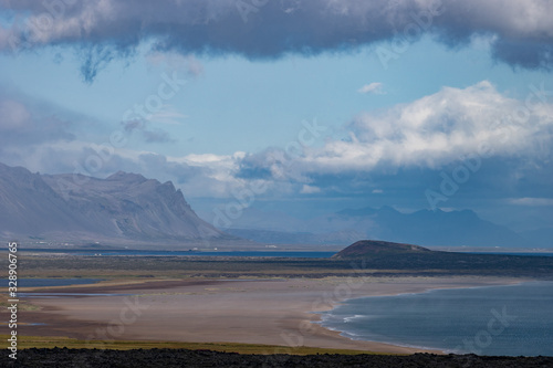 Icelandic landscape with mountains  blue sky and green grass on the foreground. West fjord part