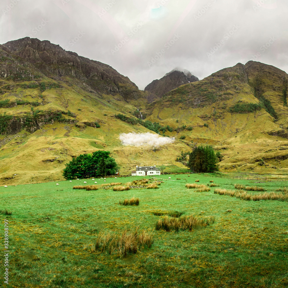 Achnambeithach cottage under the cloud and rain in Scotland. Green scottish landscape. Famous house in northern Scotland. 