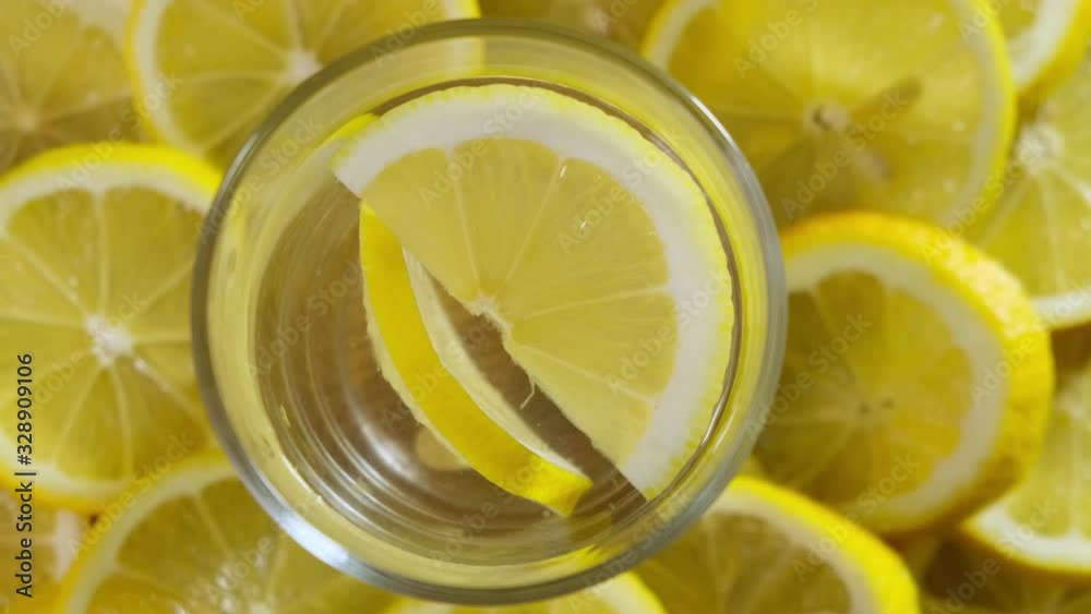 Glass soda water with lemon slices Rotating. Top view. Close up. Glass soda water with lemon slices Rotating. Top view. Close up.