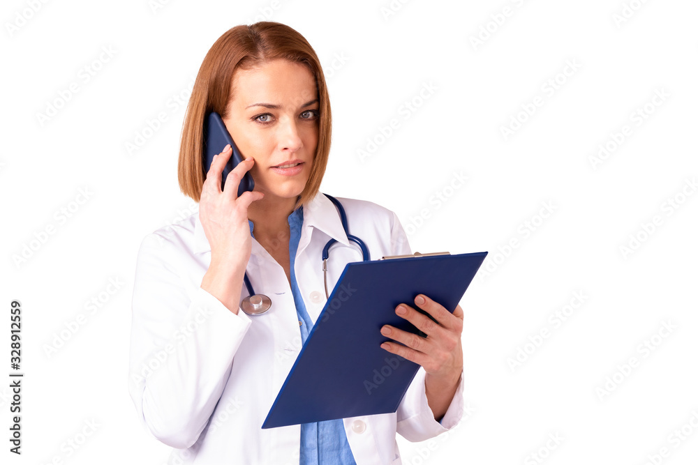 Mature female doctor using her mobile phone while standing at isolated white background Mature female doctor using her mobile phone while standing at isolated white background