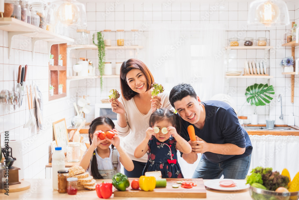 Asian family enjoy playing and cooking food in kitchen at home - obrazy, fototapety, plakaty 