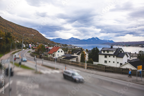 View of Tromso, with cathedral, Tromso Bridge, Tromsoya island, embankment and scenery beyond the city, Troms og Finnmark county, Norway, summer day © tsuguliev