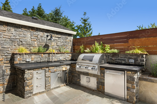 Home exterior backyard hardscape outdoor entertainment and cooking area with barbecue photo