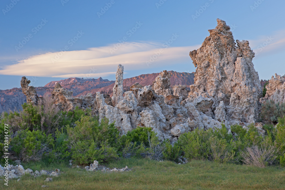 Landscape of tufa formations at Mono Lake and the White Mountains with lenticular clouds hovering above, California, USA