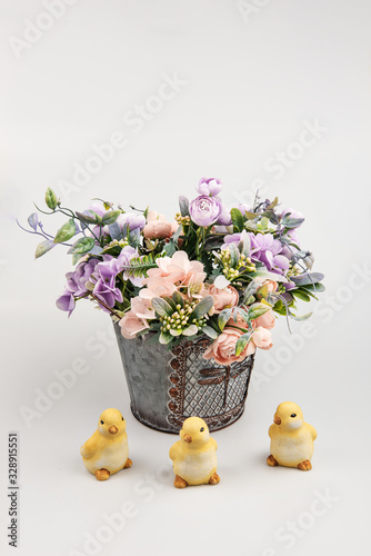 bouquet of flowers in vase and trhree chicks photo