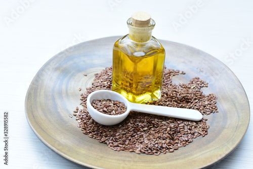 Flaxseed or flaxseed seeds, accompanied by oil (Linum usitatissimum) displayed in containers