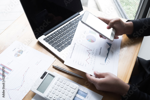 Business woman are discussing about business graph on the table in the office room