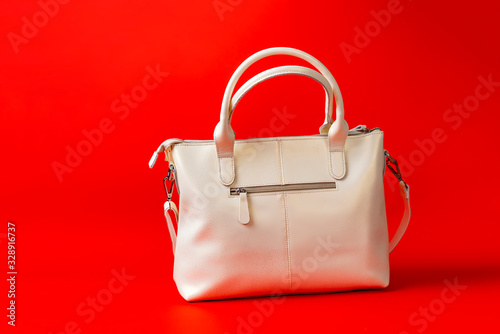 simple leather white women bag isolated on the colorful background, female accessories storage
