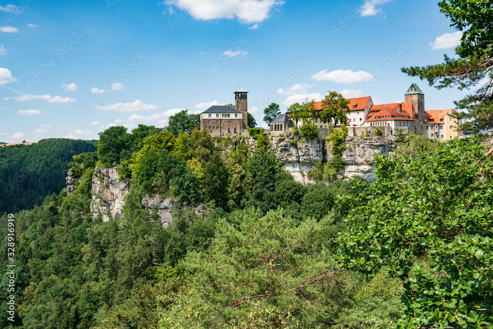 Bad Schandau in Bohemian Switzerland. Bastei bridge and mountain view. Narrow rock, natural sandstone arch in Europe..Hill scenery with greenery, blue sky and sunlight.