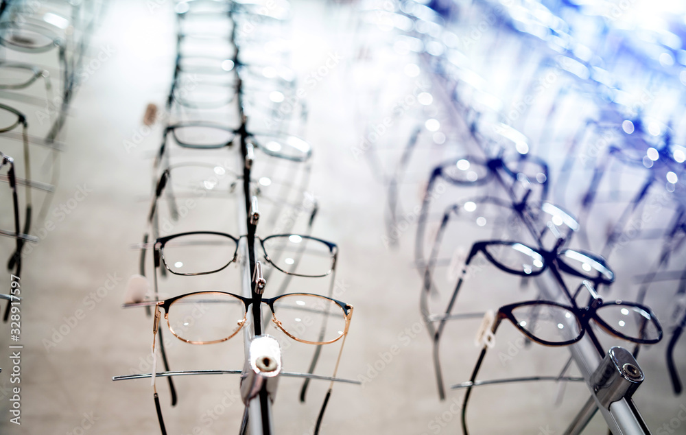 Showcase with spectacles in modern ophthalmic store. Exhibition of glasses at shelves. Showcase with spectacles in modern ophthalmic store. Exhibition of glasses at shelves.