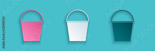 Paper cut Fire bucket icon isolated on blue background. Metal bucket empty or with water for fire fighting. Paper art style. Vector Illustration