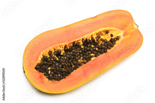 Half cutted off ripe tasty papaya fruit with juicy orange pulp indoor studio photo isolated on white background top view close up