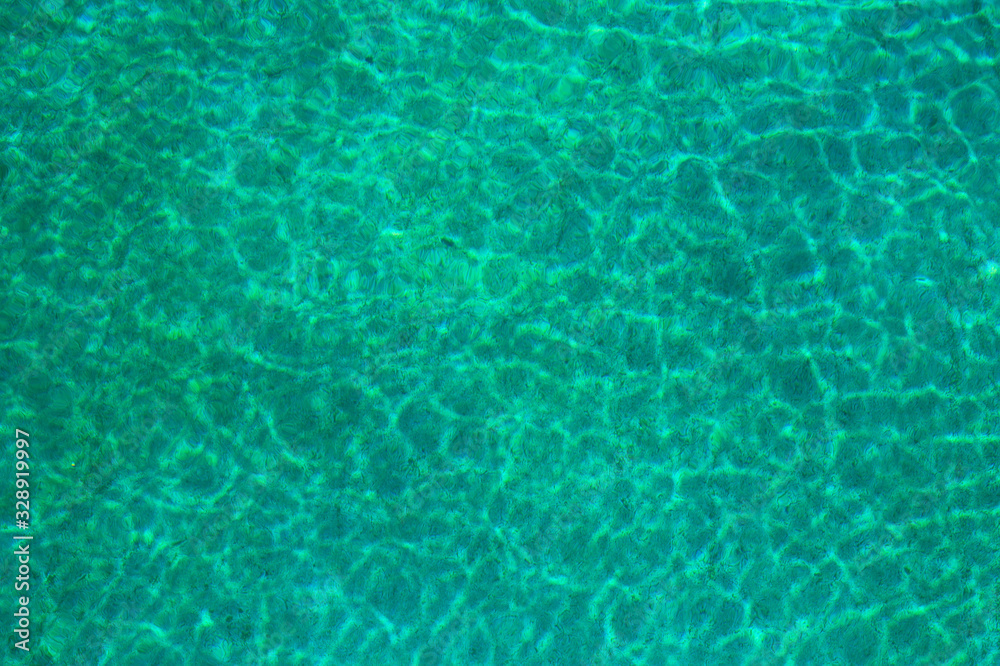 turquoise water surface with sun reflection..blurred abstract image of a water surface.photo of the surface of the water in hot summer weather