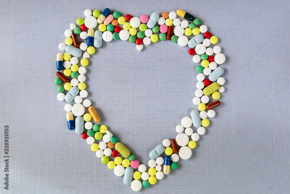 Heart shaped frame made of different coloured pills and medicine capsules
