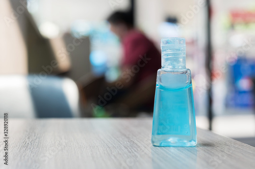 wash hand sanitizer gel bottle against Novel coronavirus or Corona Virus Disease (Covid-19) at office Indoor. Antiseptic, Hygiene and Healthcare concept