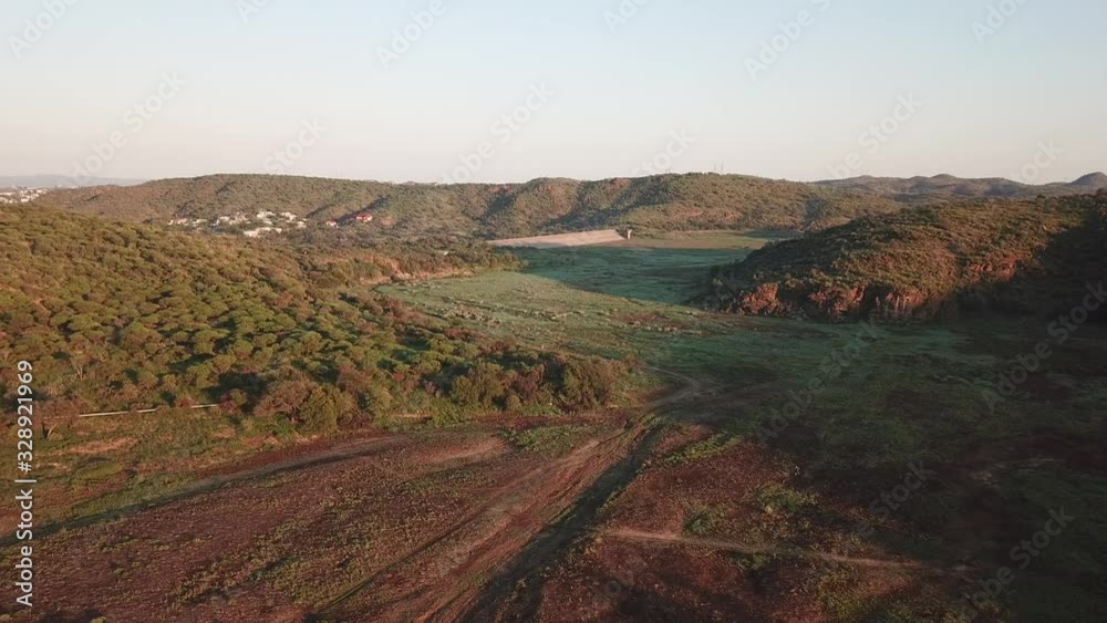 4K aerial drone video of greeen savanna hills and Avis Dam near historical railway bridge on main B6 road from Windhoek to Gobabis in central highland Khomas Hochland of Namibia, southern Africa