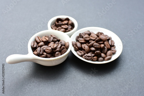 Colombian coffee beans  displayed in containers on black background
