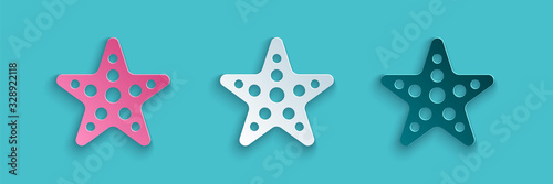 Paper cut Starfish icon isolated on blue background. Paper art style. Vector Illustration