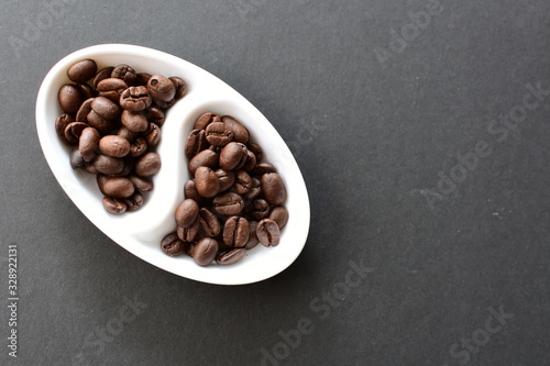 Colombian coffee beans, displayed in containers on black background