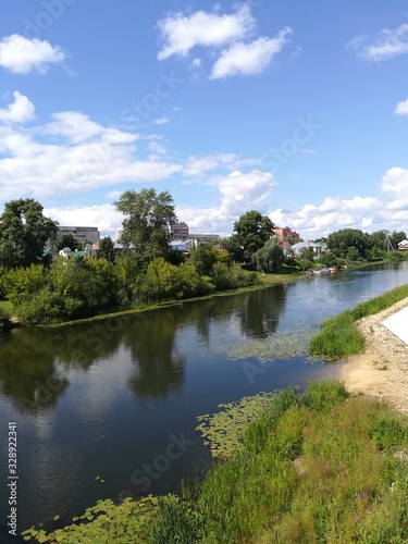 river on a background of blue sky and green trees