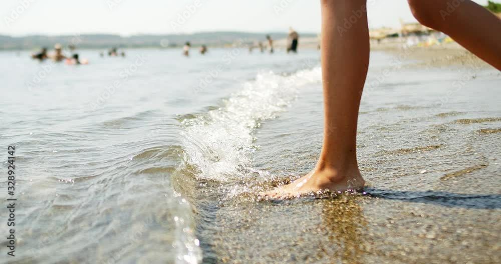female feet step on the sea female feet step on the sea