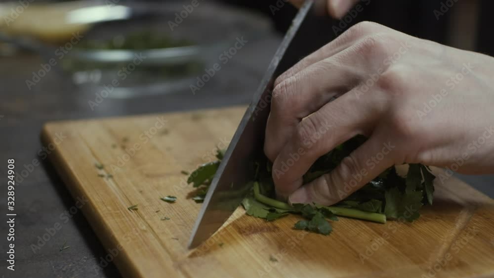 Cutting greens on kitchen close up, slow motion Cutting greens on kitchen close up, slow motion