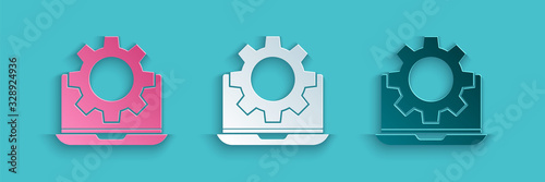 Paper cut Laptop and gear icon isolated on blue background. Adjusting app, setting options, maintenance, repair, fixing. Paper art style. Vector Illustration