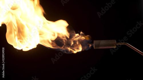 Flames from a gas burner on a black background.