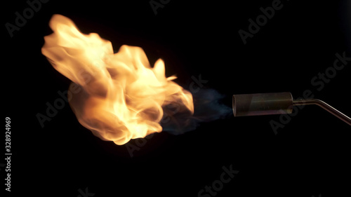 Flames from a gas burner on a black background. Close-up.