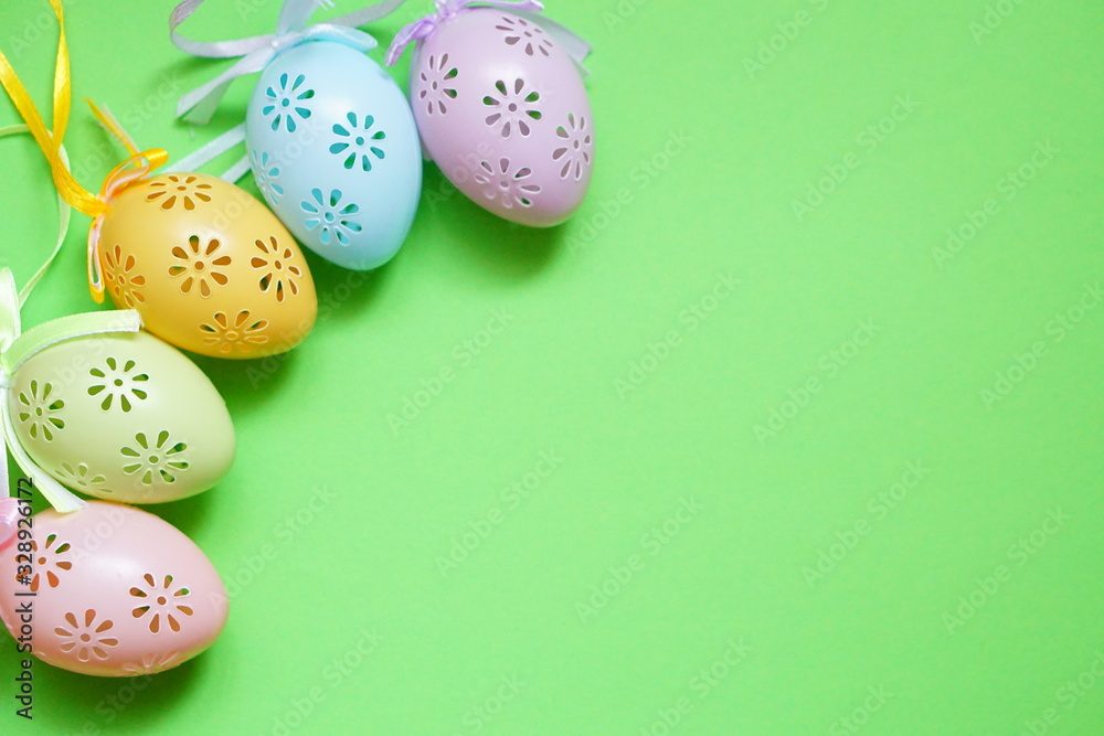 Colored lace Easter eggs on green background