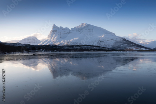 Panorama of snowy fjords and mountain range  Senja  Norway Amazing Norway nature seascape popular tourist attraction. Best famous travel locations. beautiful sunset within the amazing winter landscape