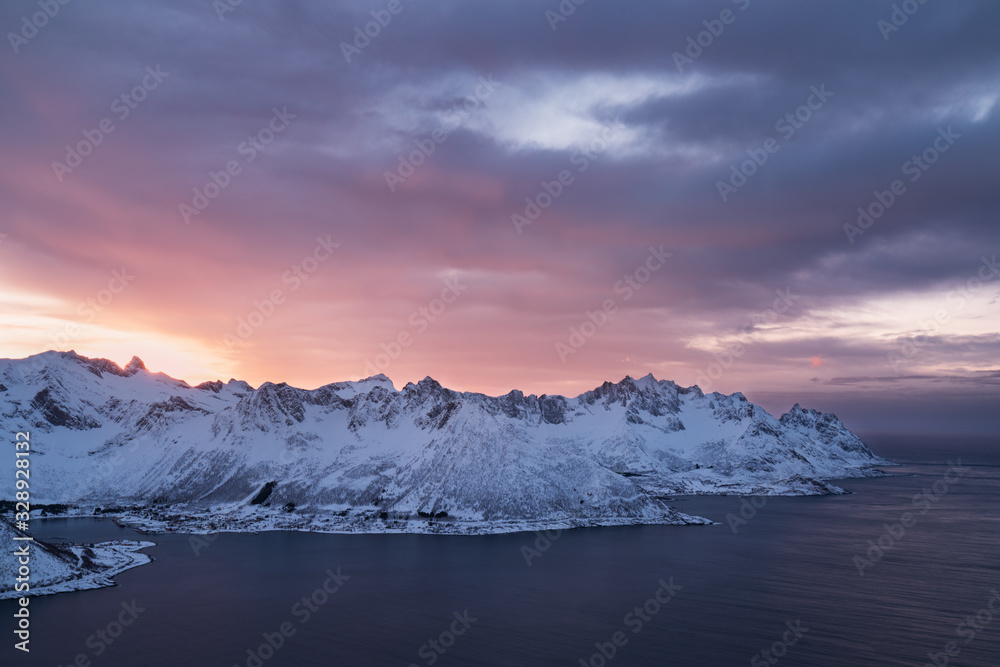 Panorama of snowy fjords and mountain range, Senja, Norway Amazing Norway nature seascape popular tourist attraction. Best famous travel locations. beautiful sunset within the amazing winter landscape